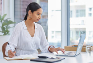 I dont sell on maybe. Shot of a businesswoman using a laptop in